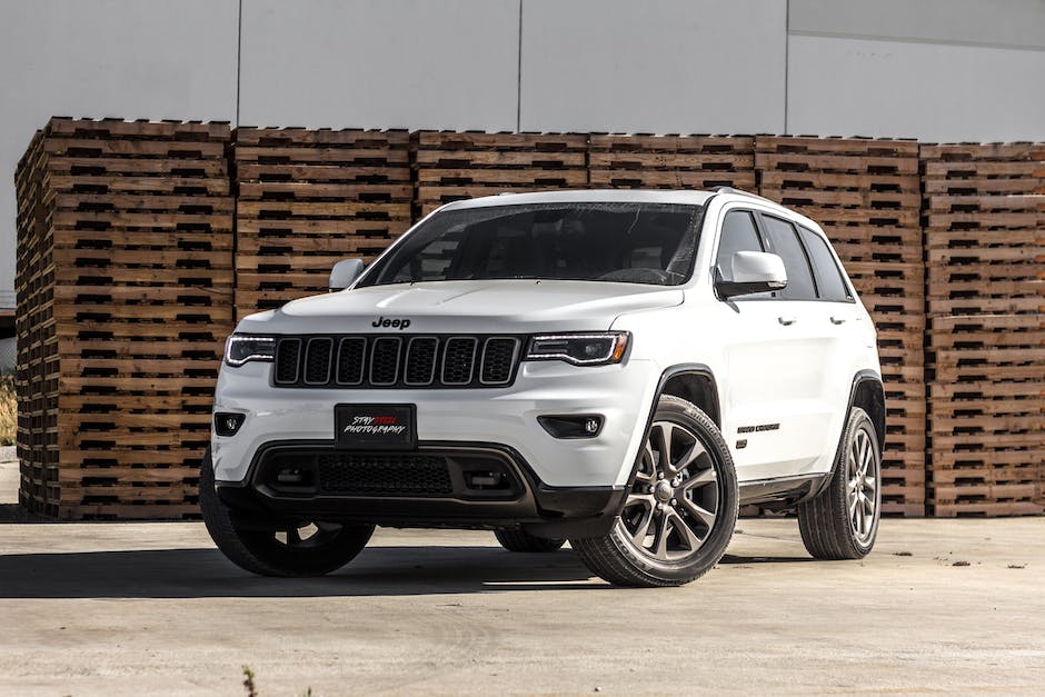 A picture of a Jeep Cherokee being checked by a mechanic during a routine maintenance