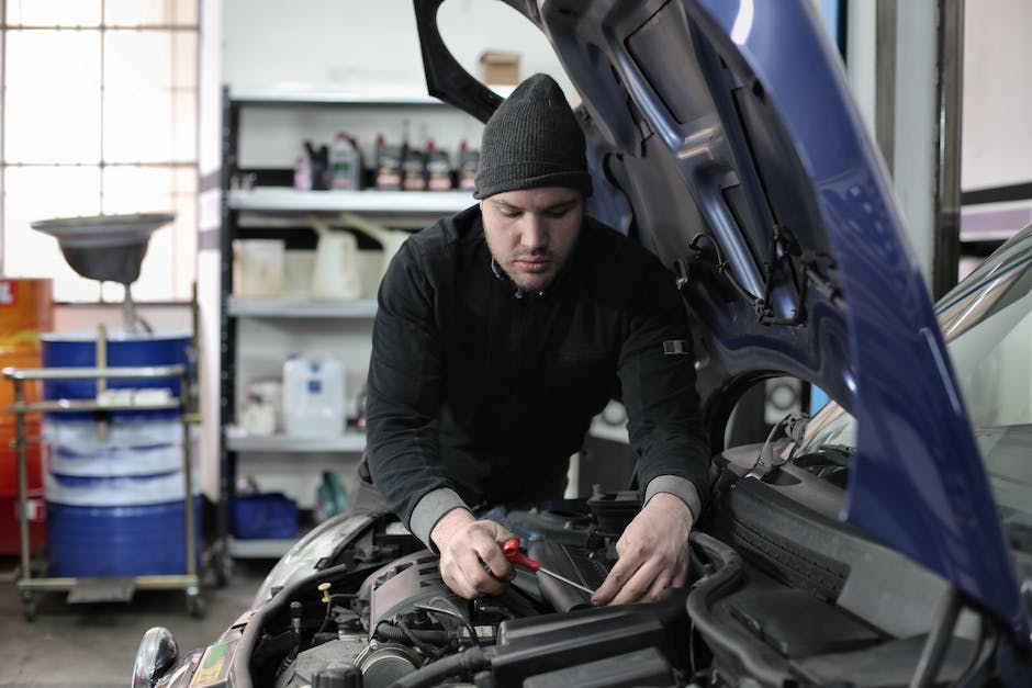 Image: A picture of a used Jeep Wrangler being inspected for body and frame integrity.